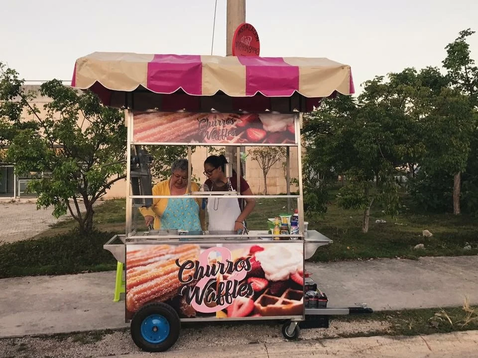 Doña Emy and Don Javi at their original Churros & Waffles street cart in Cancún, 2016